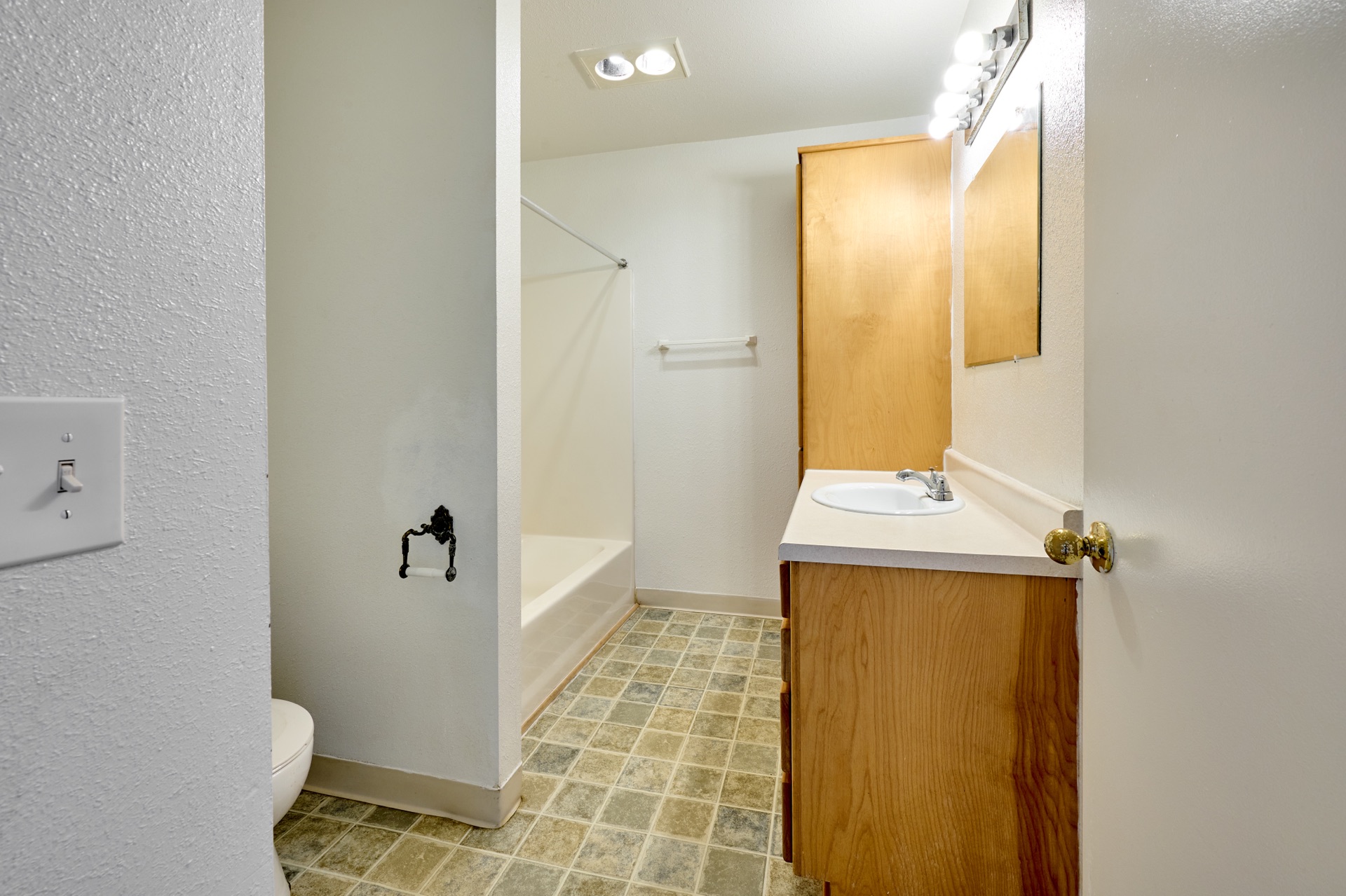 Bathroom with vanity and tub shower